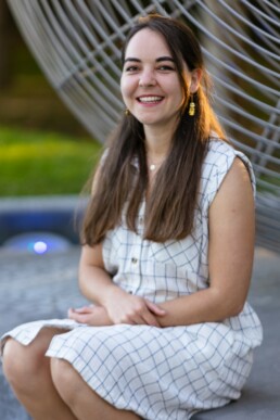 Image of Vivien sitting in a white dress.